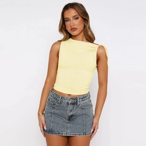 Detail of yellow one-shoulder drawstring crop top with side ruching and neck tie design