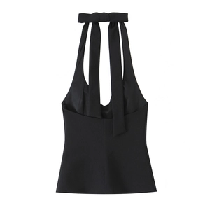 Detail of black halter top featuring a back bow tie and premium suit fabric texture