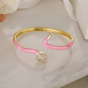 Bohemian gold snake bracelet with pink enamel and sparkling white zircon accents