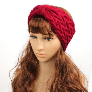 Close-up of red cable knit headband with warm fleece lining for winter ear protection