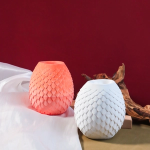 Detailed close-up of textured silicone mold and finished orange scale pattern vase