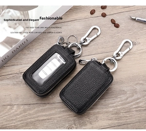 Detail view of lychee grain leather car key cases with window and metal zip in business setting