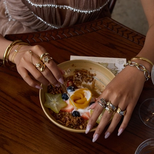 Elegant gold and silver star rings with matching bracelets on female hands