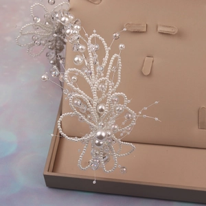Detail of handcrafted bridal headband with white faux pearls and delicate silver wires