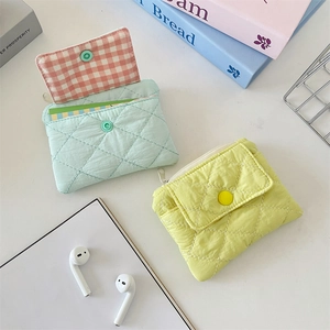 Detailed quilted coin purse in mint green and lemon yellow with snap button and zipper