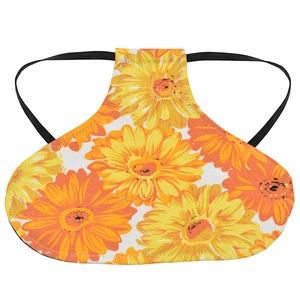 Detail of yellow floral chicken saddle protector with elastic straps and canvas fabric