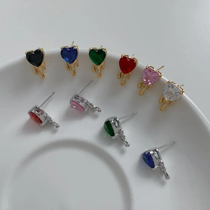 Detail shot of heart-shaped zircon earrings with metal drip design in various colors