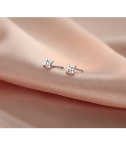 Macro view of S925 sterling silver four-pointed star earrings with sparkling zircon