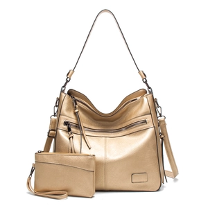 Detail of champagne gold tote bag set with zippers and adjustable shoulder strap