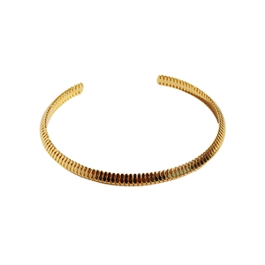 Minimalist gold spiral textured open bangle with a polished metallic finish on white background