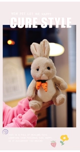 Close-up of a plush light brown bunny toy with cute small carrot decorations
