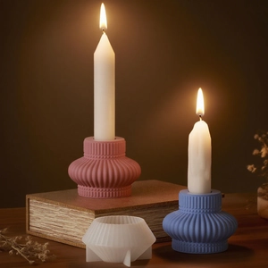 Detailed view of striped resin mold with elegant finished candle holders on a wooden desk