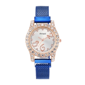 Detail of rose gold rhinestone bezel and blue sunray dial on Milanese mesh watch
