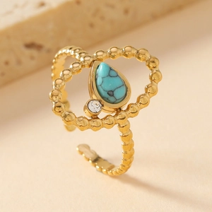 Adjustable gold plated stainless steel ring featuring teardrop turquoise and white crystal