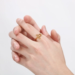 Minimalist gold Ankh cross ring in stainless steel shown on a model's finger