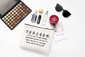 Detailed flat lay of teacher theme canvas makeup bag with premium travel accessories