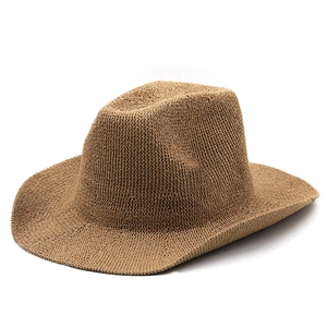 Detailed close-up of dark beige straw fedora featuring dense spiral weave and indented crown