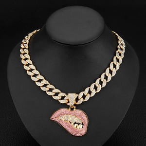 Hip hop Cuban chain necklace with pink rhinestone lips and gold teeth pendant on black bust