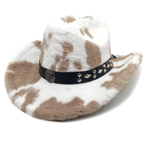 Detail of plush cow print cowboy hat with studded leather band and vintage metal emblem