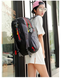 Detail of outdoor backpack with red zippers, yellow cords and side mesh pockets