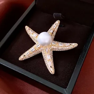 Exquisite 14K gold plated starfish brooch with a large pearl and sparkling zircon accents