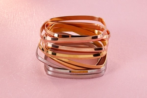 Close-up of minimalist square stackable bangles in gold, rose gold and silver finish