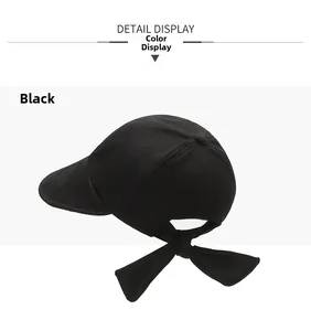 Detail of black cotton baseball cap featuring a decorative back bow and six-panel crown
