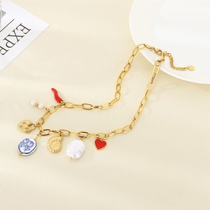 Detailed close-up of gold chunky link necklace featuring shell, pearl, and heart charms