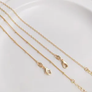Close-up of 14KGF gold filled necklace chain with lobster clasp and extension