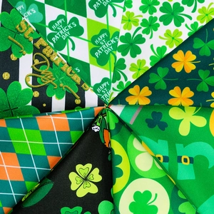 Multiple Saint Patrick's Day pet bandanas with green clover patterns and holiday prints