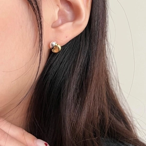 Minimalist 925 sterling silver dual-tone interlocking ear studs worn by model