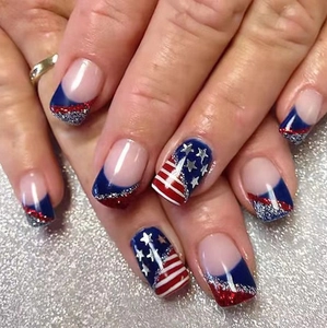 Detail of square nails with USA flag stripes and stars design in red blue silver glitter