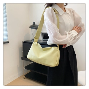 Detail of soft leather crossbody tote bag with wide strap and adjustable metal buckle