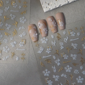 3D floral nail stickers with white and gold patterns and elegant pearl accents