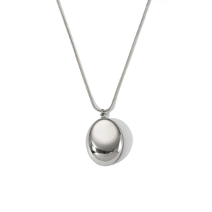 Close-up of a polished silver oval pendant necklace with a fine snake chain detail