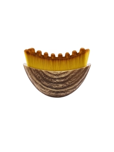 Macro detail of the U-shaped curved foundation brush with yellow ombre bristles and wood base