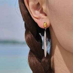 Modern two-tone drop earrings with gold oval studs and silver streamline pendants