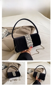 Detail of black velvet evening bag with sparkling rhinestone buckle and silver chain