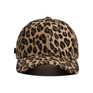 Detail of adjustable metal buckle and leopard print canvas texture on baseball cap