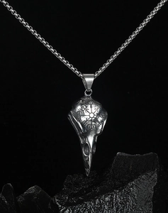 Detailed view of Viking raven skull pendant on black stone with round link chain