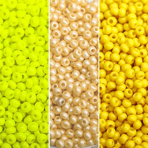 Close-up comparison of yellow and pearl white round beads for DIY jewelry making