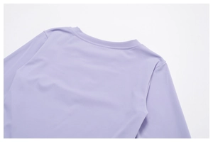Detailed close-up of the reinforced crew neck on this lilac long-sleeve yoga top