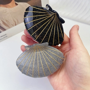 Minimalist shell-shaped hair claw clips with glitter gold stripes and rhinestones