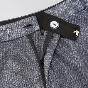 Close-up of the zipper, white button, and glitter texture on these navy blue trousers