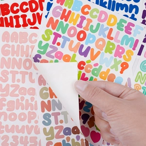 Close-up showing the easy-peel adhesive backing of colorful alphabet stickers