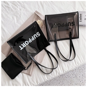Detail of transparent PVC tote bag with Support text and inner pouch on white bedding