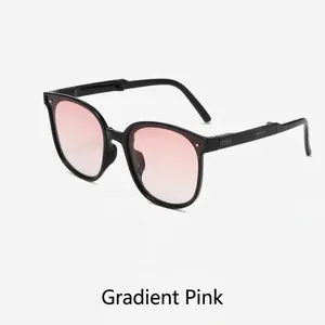 Foldable gradient pink sunglasses with stylish black frame shown in a side view angle