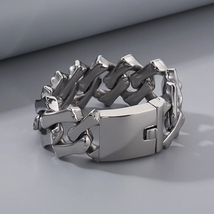 Close-up of 32mm thick polished silver-tone stainless steel Cuban chain with rectangle clasp