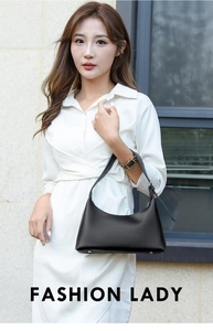 Close-up of the black leather underarm bag featuring protective silver metal bottom studs