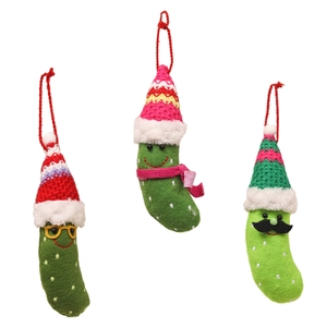 Three creative knitted Christmas pickle ornaments with glasses and festive hats